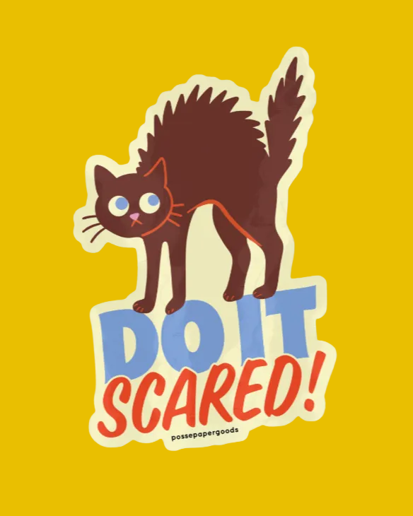 Sticker of a cat with 'DO IT SCARED!' text on a light gray background