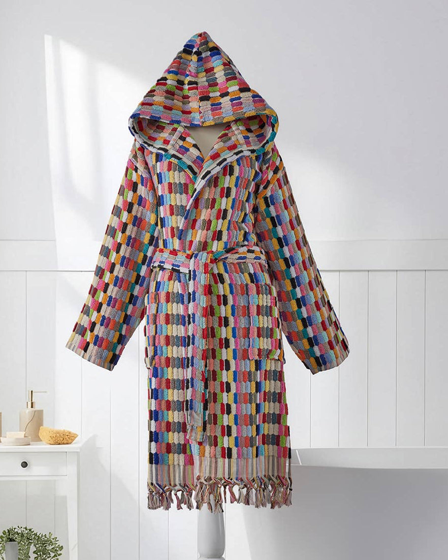 Colorful checkered bathrobe on a stand in a bathroom setting