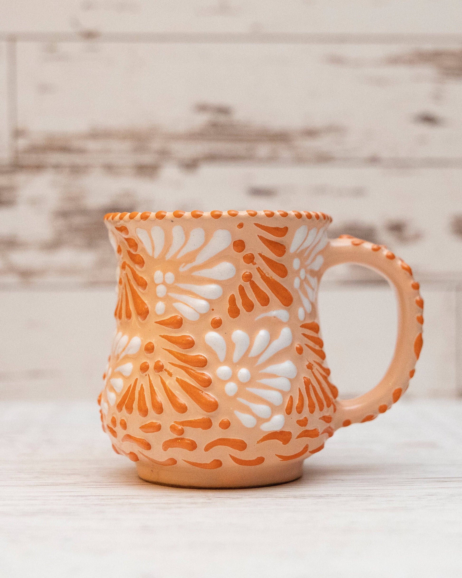 Ceramic mug with floral pattern on a wooden surface