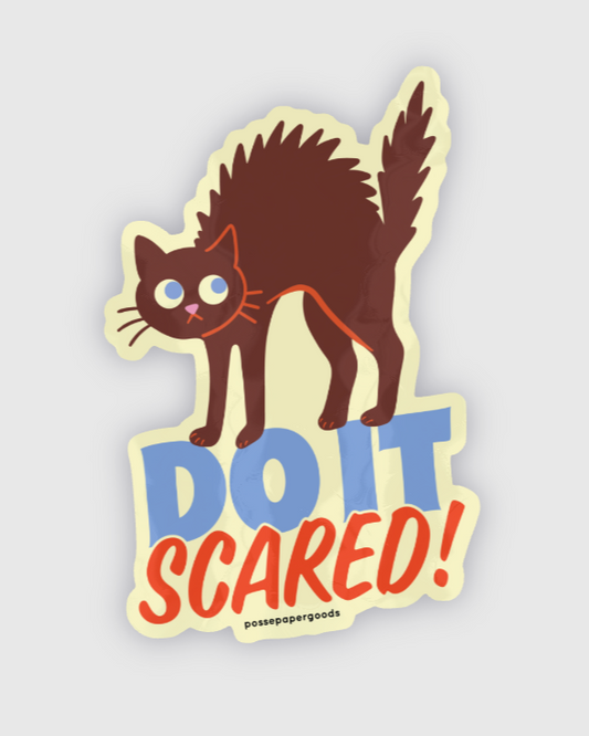 Sticker of a cat with 'DO IT SCARED!' text on a light gray background